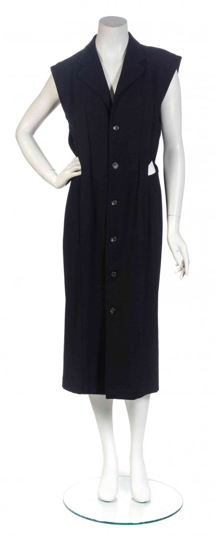 A Comme des Garcons Black Wool Dress, Size S.: A Comme des Garcons Black Wool Dress, sleeveless, with buttons down the center front and side cutouts at the waist. Labeled: Comme des Garcons. Size S. Condition: Overall very good condition. Please n