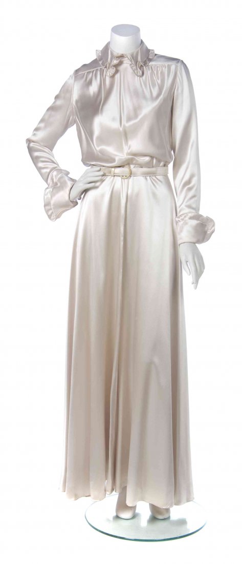 A Galanos Champagne Satin Gown,: A Galanos Champagne Satin Gown, long sleeves, with a ruffled peter pan collar and ruffled cuffs, together with a matching belt. Labeled: Galanos. Condition: Measurements Bust: 14" flat Waist: 13" flat