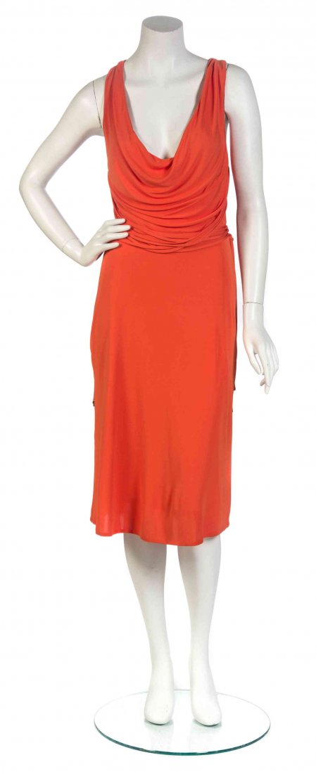 A Gianni Versace Orange Jersey Dress, Size 42.: A Gianni Versace Orange Jersey Dress, cowl neck with multi criss-cross straps to the back. Labeled: Versace. Size 42.