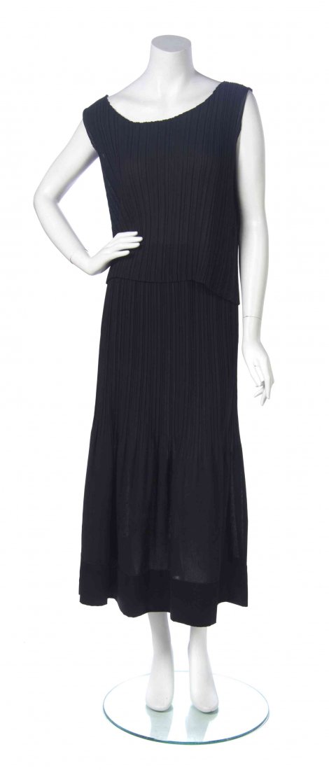 An Issey Miyake Black Pleated Skirt Ensemble, Size M.: An Issey Miyake Black Pleated Skirt Ensemble, comprised of a sleeveless boxy top and a full length skirt with a satin trim hem. Labeled: Issey Miyake. Size M. Property from the Estate of Dorothy Parro