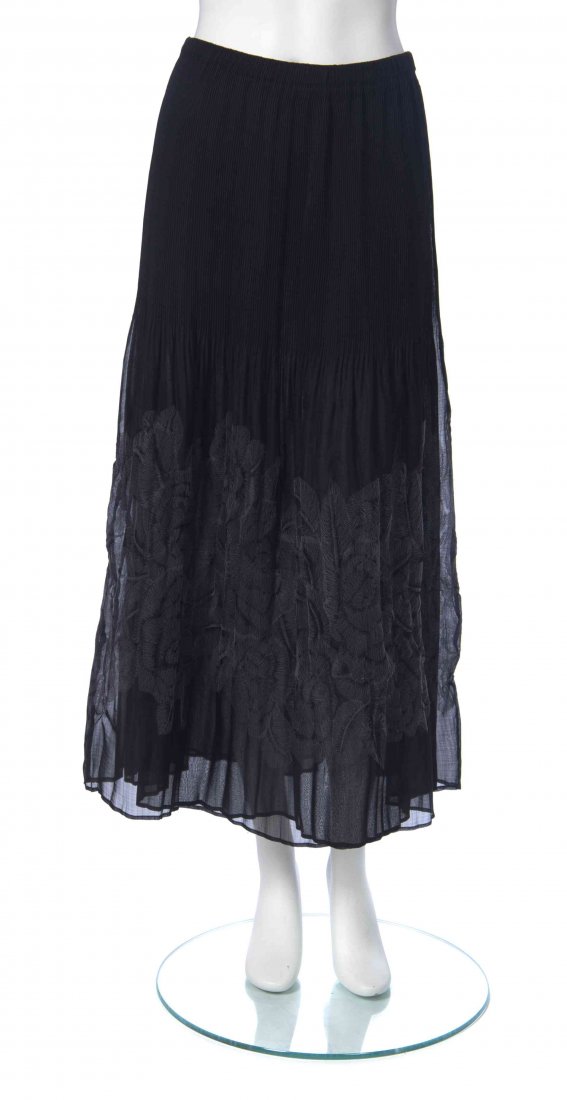 A Group of Issey Miyake Garments,: A Group of Issey Miyake Garments, comprised of a sleeveless beige and brown stripe top, a black pleated skirt with a purple embroidered hem, and a black pleated skirt with circular impressions. All la
