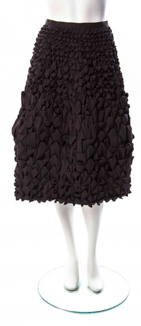 An Issey Miyake Charcoal Smocked Origami Skirt,: An Issey Miyake Charcoal Smocked Origami Skirt, in an A-line silhouette. Labeled: Issey Miyake.