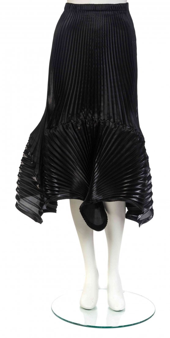 A Pair of Issey Miyake Black Skirts, Both size S.: A Pair of Issey Miyake Black Skirts, comprised of a glossy pleated skirt with a voluminous, curvilinear hem, together with a crinkled mid length skirt, with a paper bag waist, pleated hem, and an atta