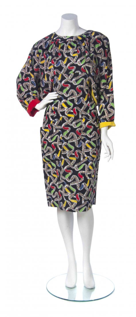 A Karl Lagerfeld Ribbon Print Dress, Size 40.: A Karl Lagerfeld Ribbon Print Dress, sleeveless, with an attached draped capelet with dolman sleeves, cinched waist, large patch pockets to hips, and a semi-open slit to the back with one hook and eye