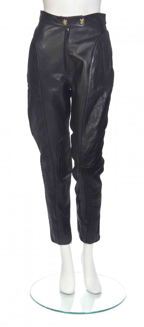 A Pair of Moschino Black Leather Pants, Size 27.: A Pair of Moschino Black Leather Pants, high-waisted, with a double goldtone button and zipper closure, slip pockets to hips, and quilted and pleated leather panels at the sides. Labeled: Moschino. Si