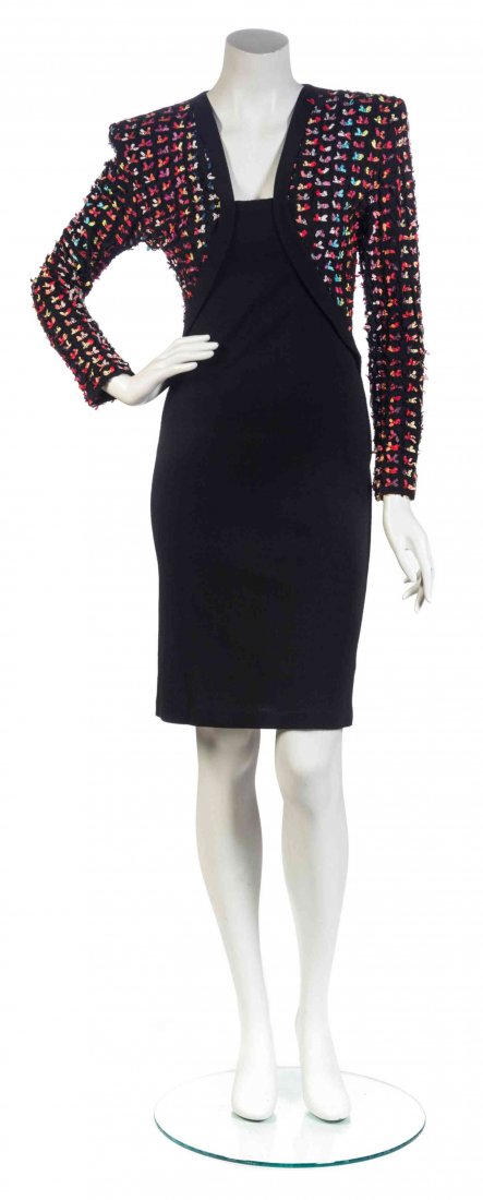A Patrick Kelly Black Knit Bow Dress, Size 6.: A Patrick Kelly Black Knit Bow Dress, 1980's, fitted silhouette with a multicolor bow applique to the sleeves. Labeled: Patrick Kelly. Size 6.