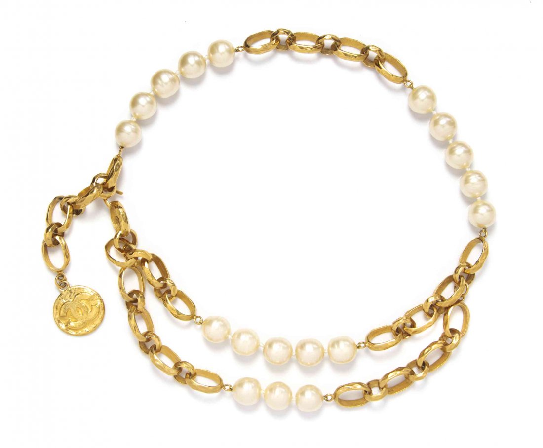A Chanel Large Faux Pearl Goldtone Chain Link Belt,: A Chanel Large Faux Pearl Goldtone Chain Link Belt, adjustable, with a hammered goldtone interlocking 'C' medallion. Stamped: Chanel. Condition: Overall very good condition. Comes with box and dustbag