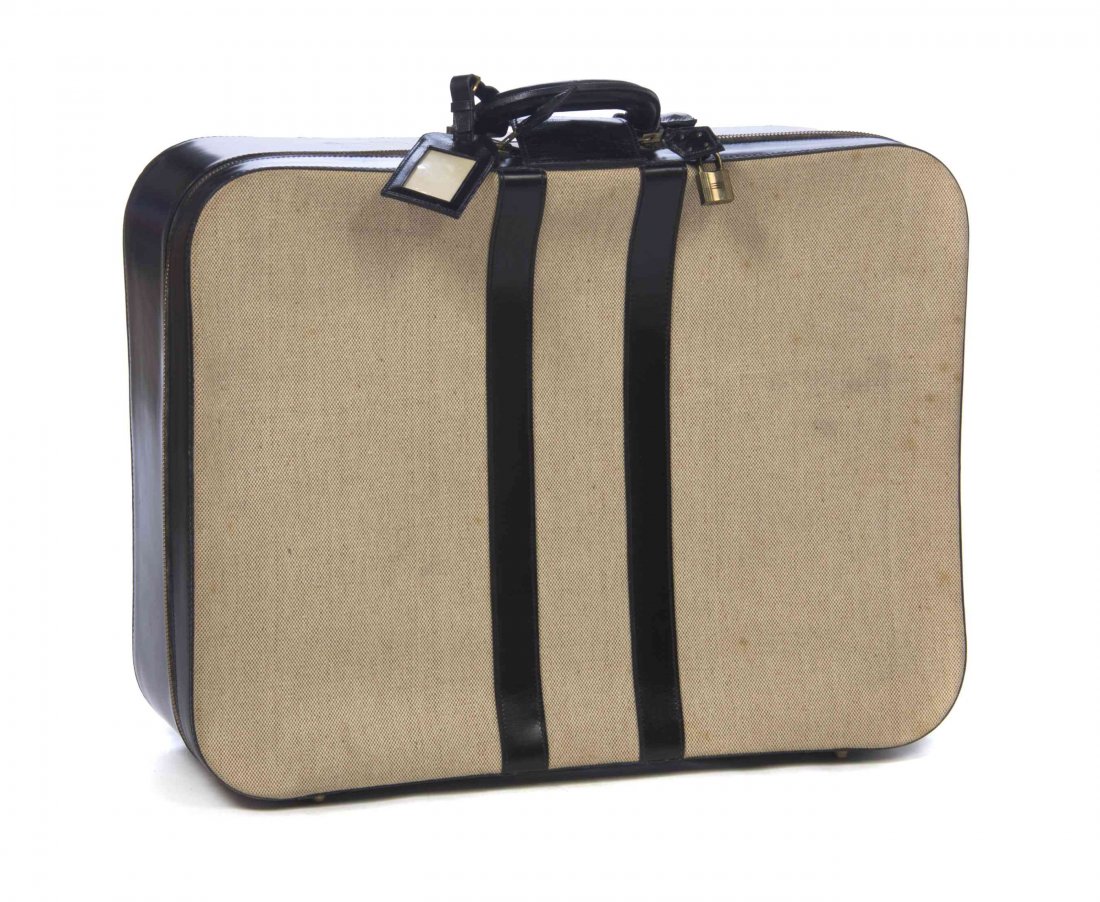 An Hermes Black Leather and Toile Suitcase, 20 x 15 x 6: An Hermes Black Leather and Toile Suitcase, single top handle, attached travel tag, lock and key sheath, black leather racer stripes to the body, double zipper closure, with two interior belt buckle s