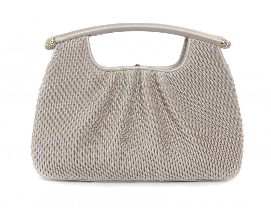 A Judith Leiber Silver Braided Satin Clutch, 9 x 5 x 2: A Judith Leiber Silver Braided Satin Clutch, two top handles with pave rhinestone detail, cabochon push clasp, drop in goldtone chain, and two interior scalloped pockets. Stamped: Judith Leiber. 9 x 5