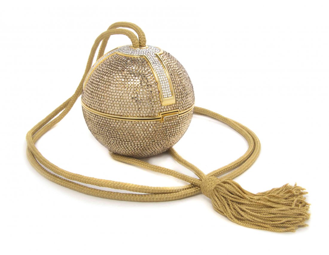 A Judith Leiber Gold Swarovski Crystal Orb Minaudiere,: A Judith Leiber Gold Swarovski Crystal Orb Minaudiere, with silver crystal geometric detail, gold passementerie strap and tassel, goldtone kid lining, accessory included. Stamped: Judith Leiber. 3 1/2