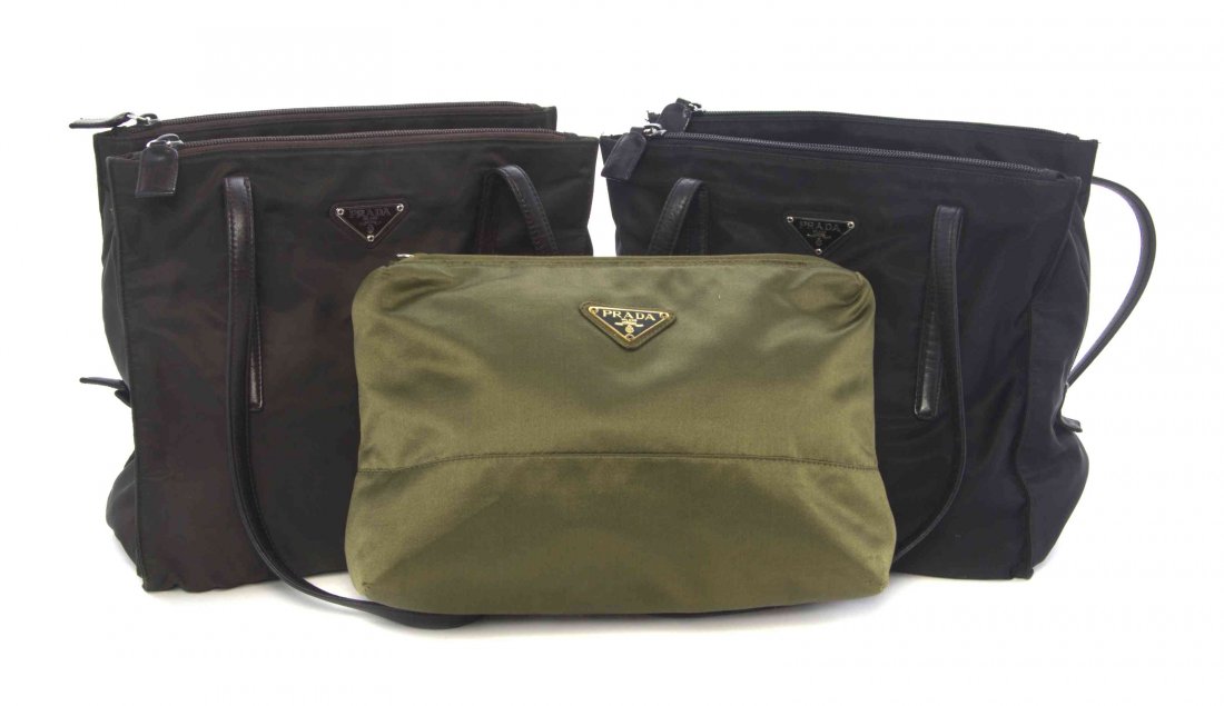 A Group of Five Prada Bags,: A Group of Five Prada Bags, comprised of one brown and two black nylon bags, each with two shoulder straps, zippered closures, and an interior zippered pocket, together with a green satin clutch and a
