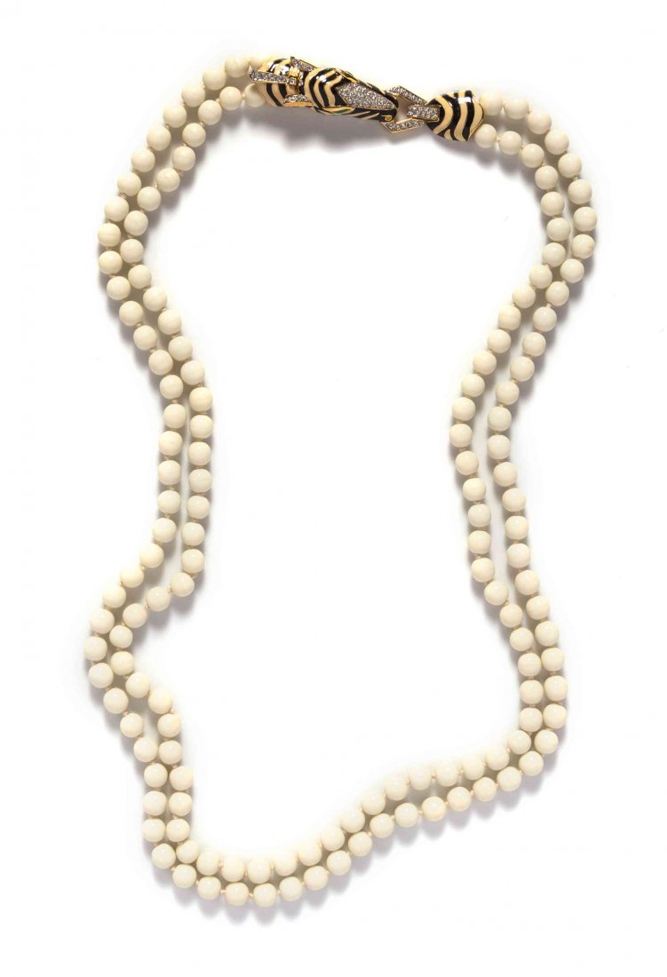 A Ciner White Bead Multistrand Necklace,: A Ciner White Bead Multistrand Necklace, with an enamel and pave rhinestone zebra head clasp. Stamped: Ciner. Together with two faux pearl necklaces, one of which is stamped: NHL Property from the Est