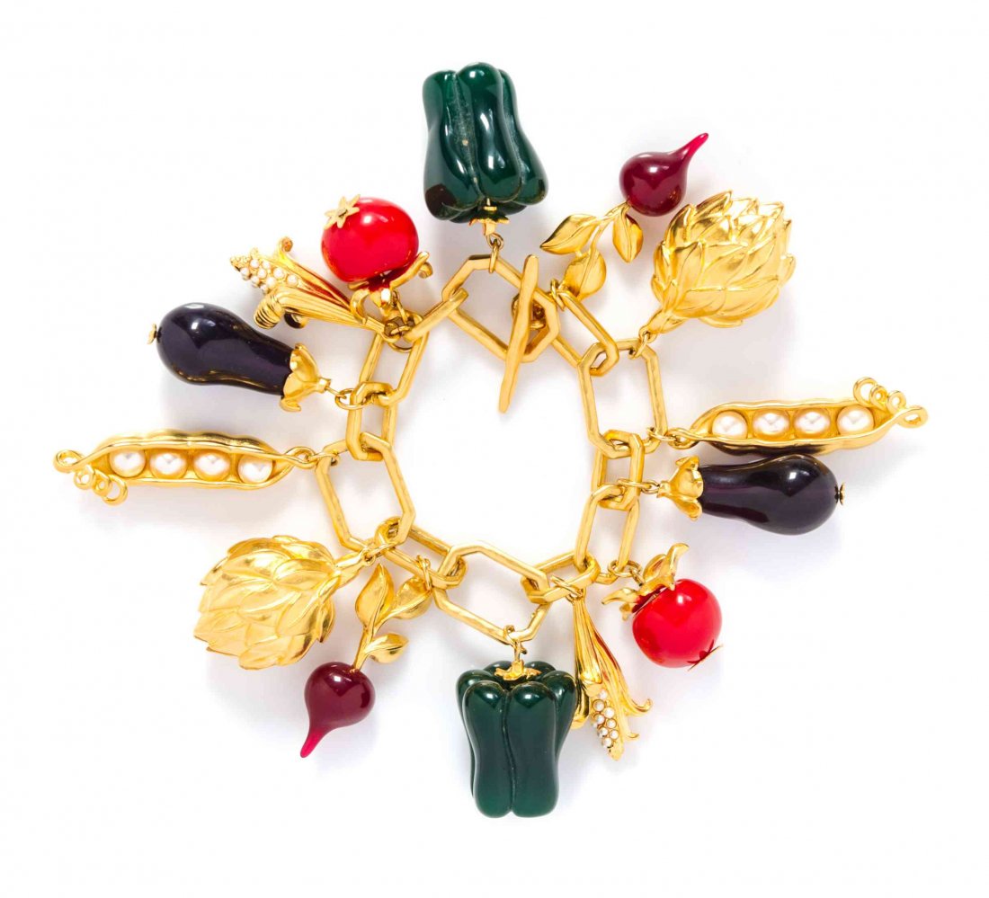 A Karl Lagerfeld Goldtone Charm Bracelet,: A Karl Lagerfeld Goldtone Charm Bracelet, with vegetable charms. Stamped: KL. Condition: Overall very good condition. Comes with Neiman Marcus box and Karl Lagerfeld dustbag.