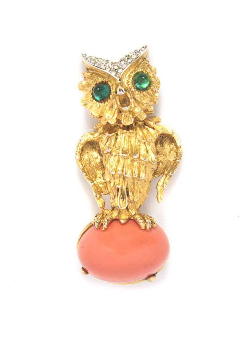 A Kenneth Jay Lane Owl Brooch,: A Kenneth Jay Lane Owl Brooch, with faux emerald and pave rhinestone details, perched on a coral cabochon stone. Stamped: K.J.L. Property from a Private Collection Condition: Overall good condition. P