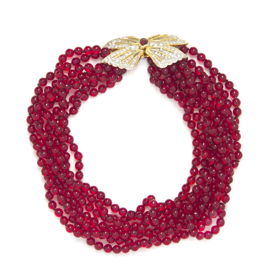A Kenneth Jay Lane Faux Ruby Multistrand Necklace,: A Kenneth Jay Lane Faux Ruby Multistrand Necklace, with a pave rhinestone butterfly clasp. Stamped: KJL. Property from a Private Collection Condition: Overall very good condition.