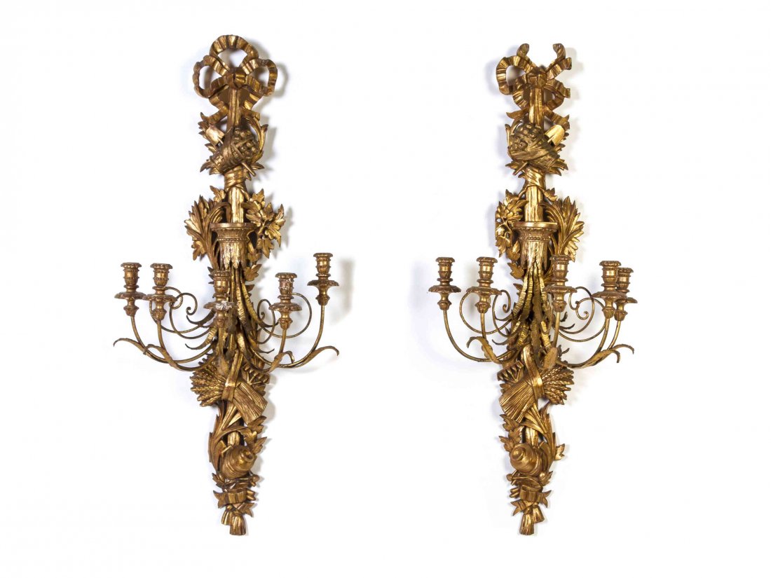 A Pair of Louis XV Style Giltwood Five-Light Sconces,: A Pair of Louis XV Style Giltwood Five-Light Sconces, each with foliate carved backplates issuing the scrolling candle arms. Height 44 inches. Property from the William S. Block Trust, Peoria, Illinoi
