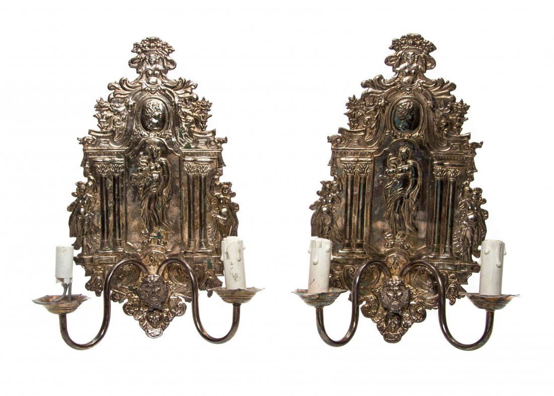 A Pair of Regence Silver-Plate Two-Light Sconces,: A Pair of Regence Silver-Plate Two-Light Sconces, each backplate worked to show classical figures and a mask issuing S-scroll candle arms. Height 16 3/4 inches.