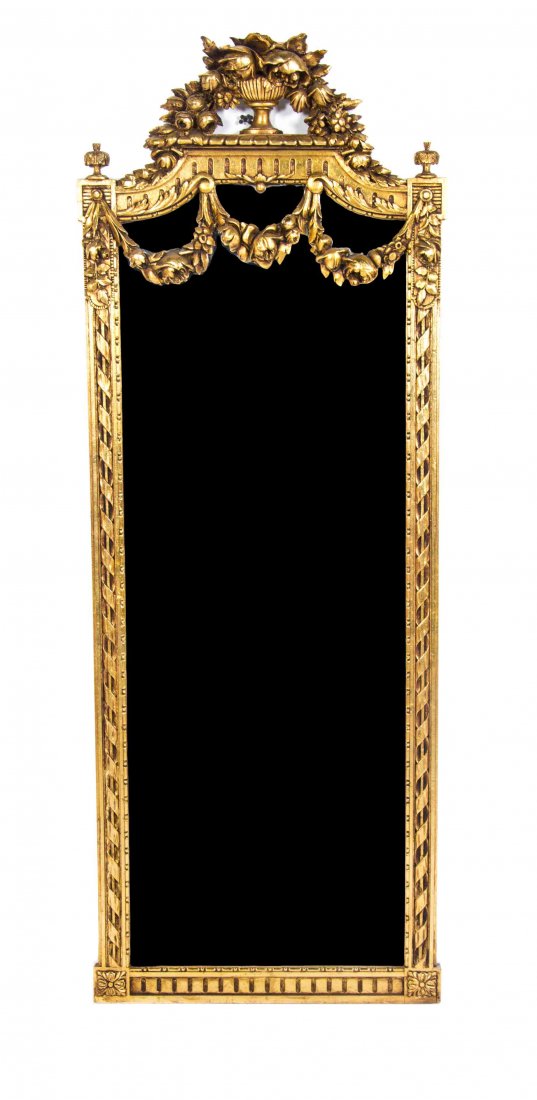 A Louis XVI Style Giltwood Pier Mirror, Height 71 1/4 x: A Louis XVI Style Giltwood Pier Mirror, having a vertical plate within a twist carved frame with a foliate crest. Height 71 1/4 x width 25 3/4 inches.