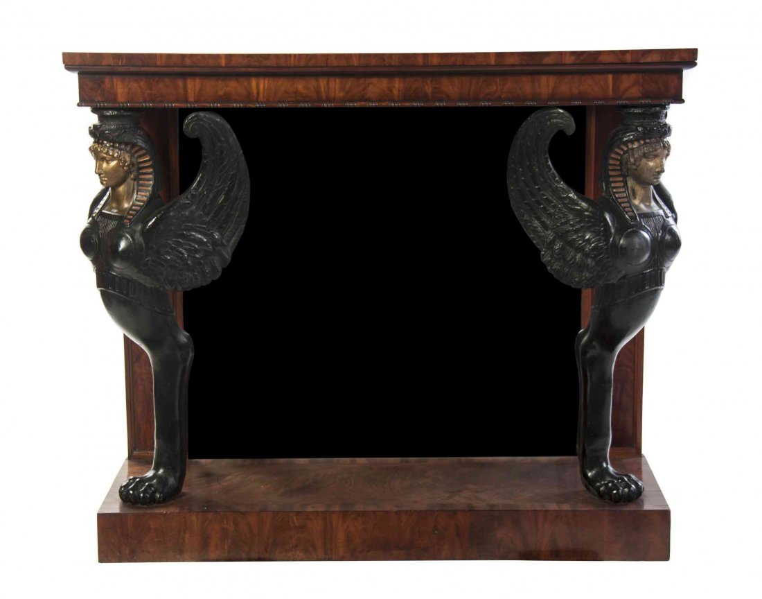 A French Empire Mahogany Console Table, Height 38 x: A French Empire Mahogany Console Table, having a figured rectangular top raised on Egyptian revival winged caryatid supports ending in monoped paw feet before a mirrored back, further raised on a rect