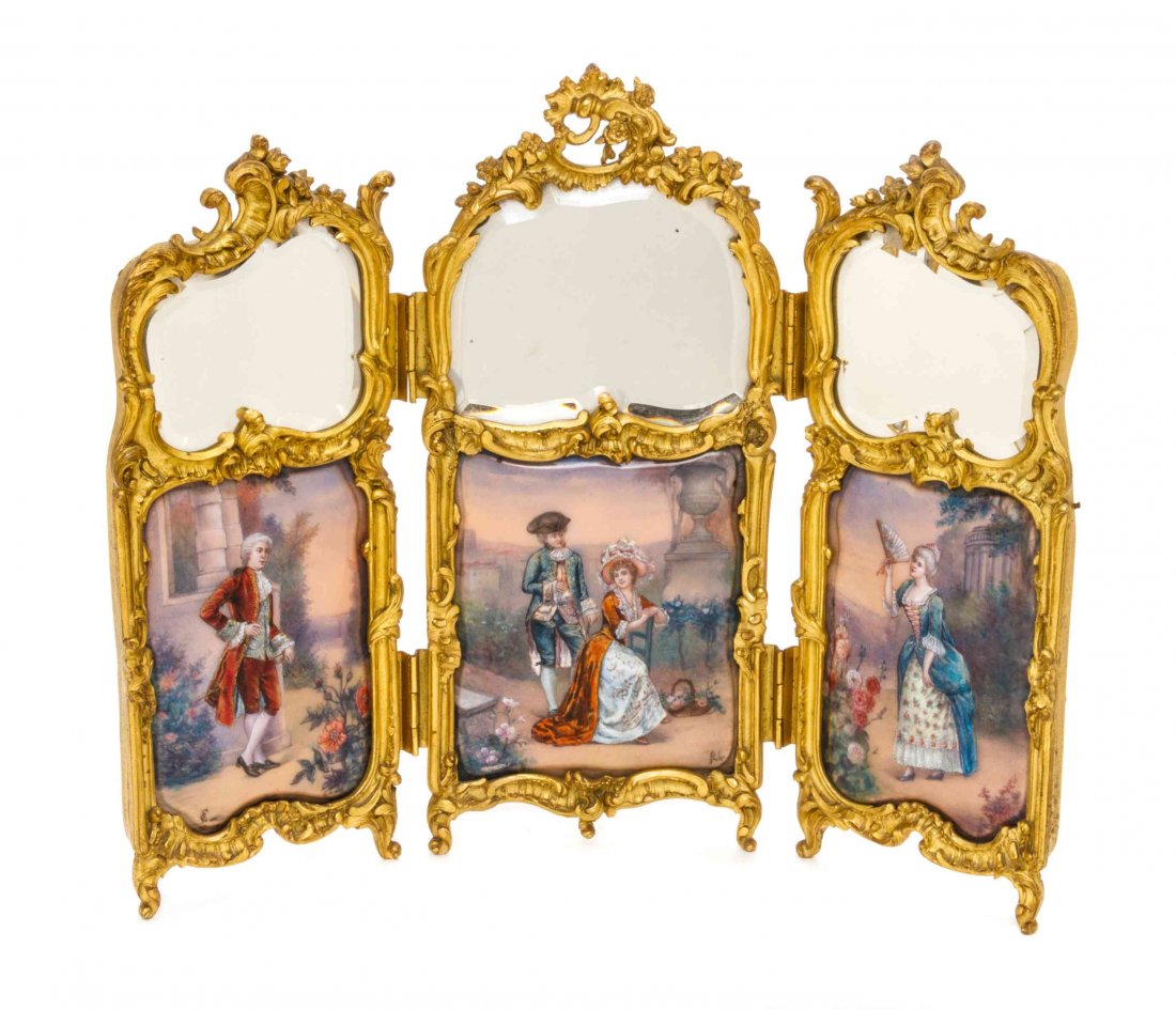 A French Enamel and Gilt Bronze Three-Panel Table: A French Enamel and Gilt Bronze Three-Panel Table Screen, each panel with figural decoration set in a foliate scroll frame. Height of tallest panel 12 inches. Property from the Estate of William Colli