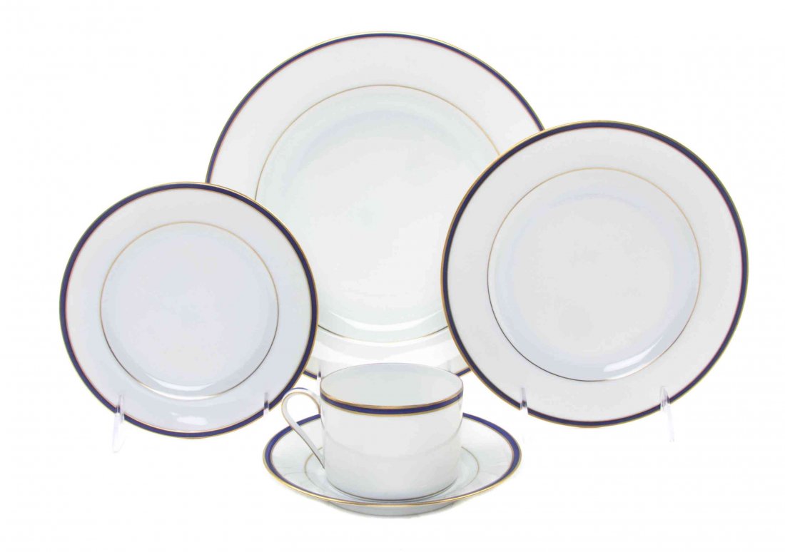 A Limoges Porcelain Partial Dinner Service, RETAILED BY: A Limoges Porcelain Partial Dinner Service, RETAILED BY TIFFANY & CO., comprising thirty-two dinner plates, seventeen salad plates, seventeen bread plates, and sixteen cups and saucers, each with gilt