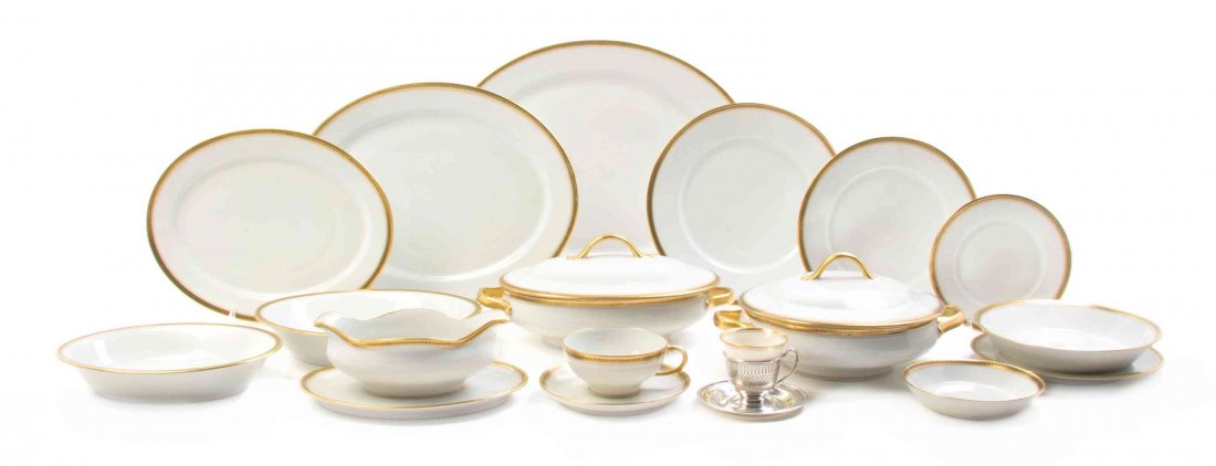 A Limoges Porcelain Partial Dinner Service, Diameter of: A Limoges Porcelain Partial Dinner Service, having a Greek key border on a cream ground, comprising twelve cups, twelve saucers, twelve finger bowls, twelve bread plates, five serving dishes, one grav