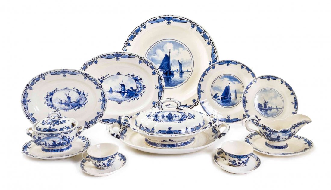 A Delft Partial Dinner Service, Width of widest 16: A Delft Partial Dinner Service, comprising platters, tureens, serving bowls, plates, teacups and others, each with blue on white windmill decoration; 61 items total. Width of widest 16 inches. Propert