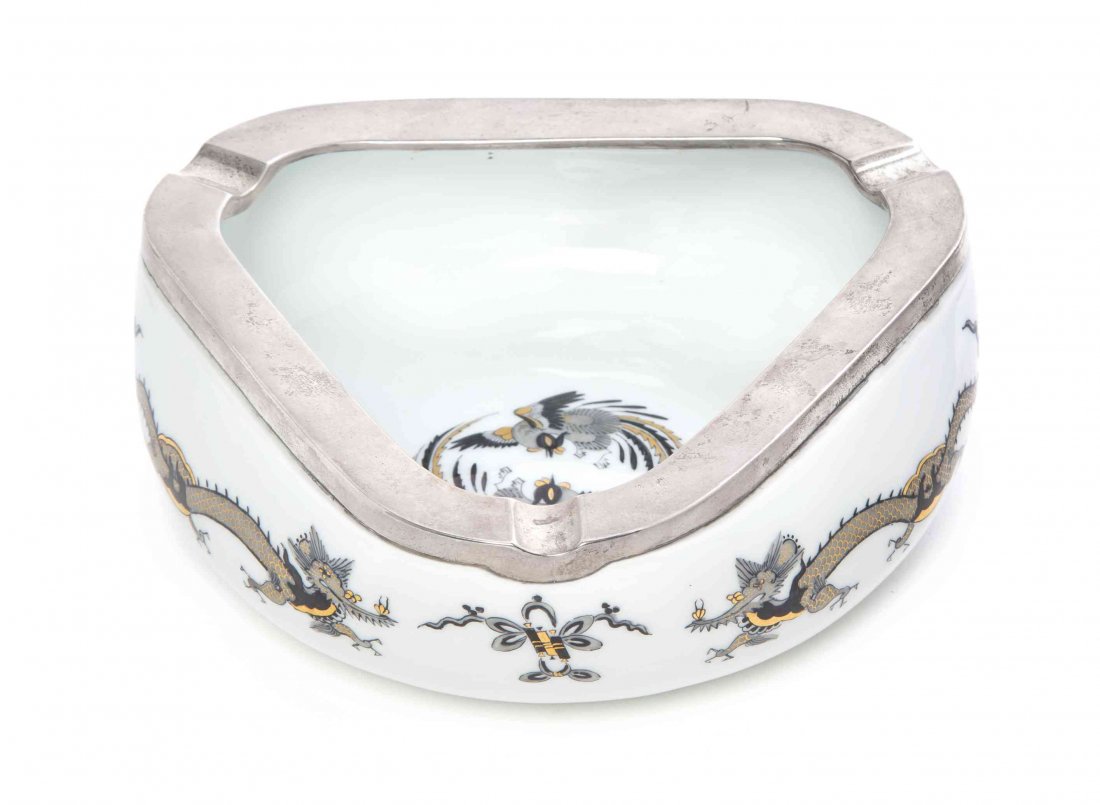 A Meissen Porcelain Ash Receiver, 20TH CENTURY, Width 8: A Meissen Porcelain Ash Receiver, 20TH CENTURY, of triangular form with a silvered metal rim, having crossed swords mark in underglaze blue. Width 8 inches.