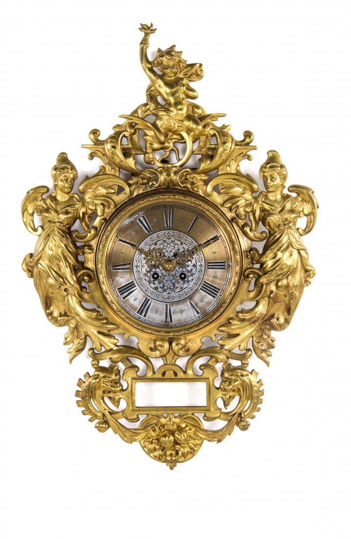 A German Gilt Bronze Wall Clock, Height 25 1/2 inches.: A German Gilt Bronze Wall Clock, having a circular dial with Roman numeral hours, flanked by female angel terms and surmounted by a cherub. Height 25 1/2 inches.