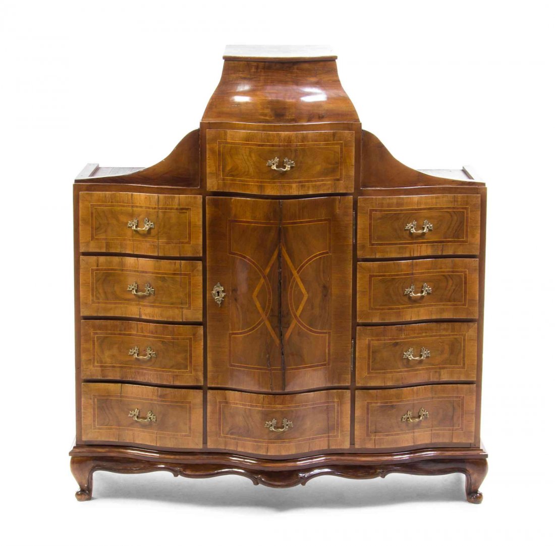 A German Walnut Table Top Cabinet, Height 42 1/2 x: A German Walnut Table Top Cabinet, having an ogee molded top above an arrangement of ten drawers and a cupboard door, raised on a shaped apron and cabriole legs ending in scroll feet. Height 42 1/2 x 
