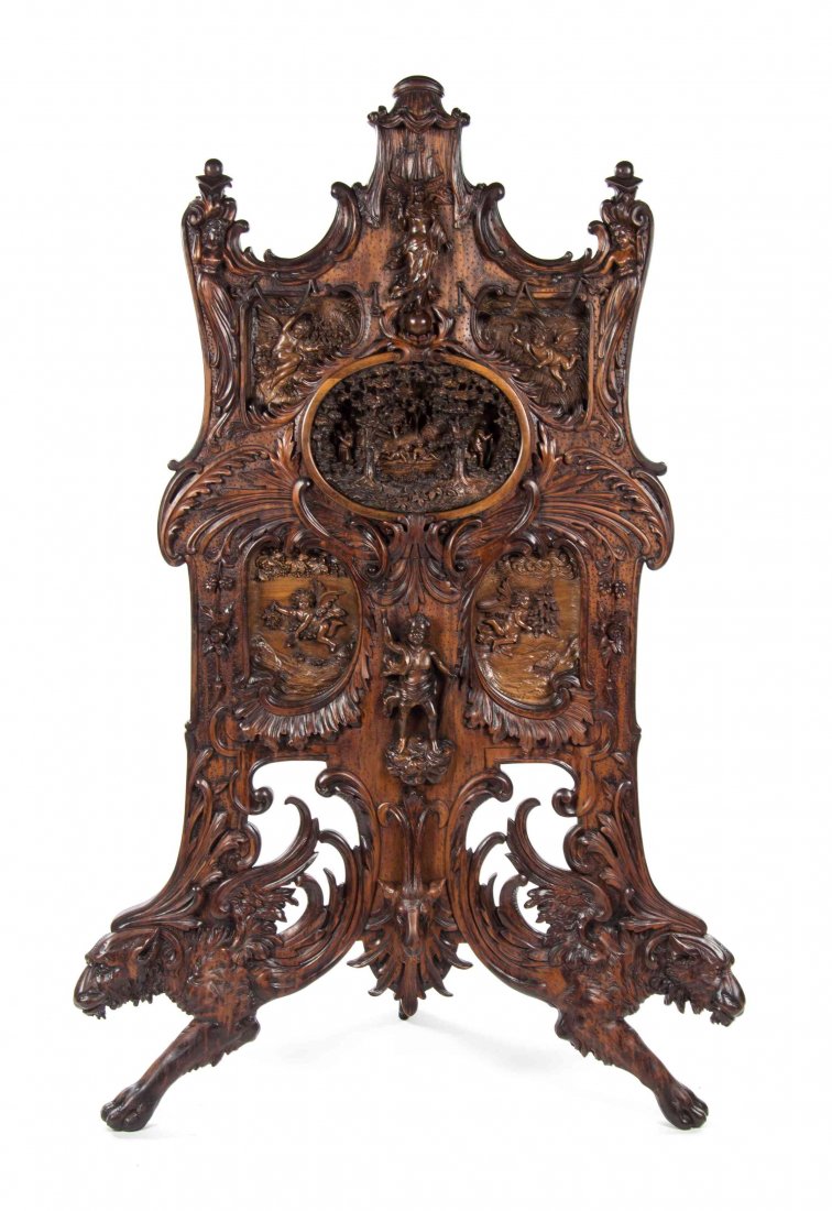 An Oversized Black Forest Carved Walnut Firescreen,: An Oversized Black Forest Carved Walnut Firescreen, relief carved with figures, figural scenes and foliate scrolls throughout, with a metal lined back. Height 67 1/2 inches. Property from the Collecti