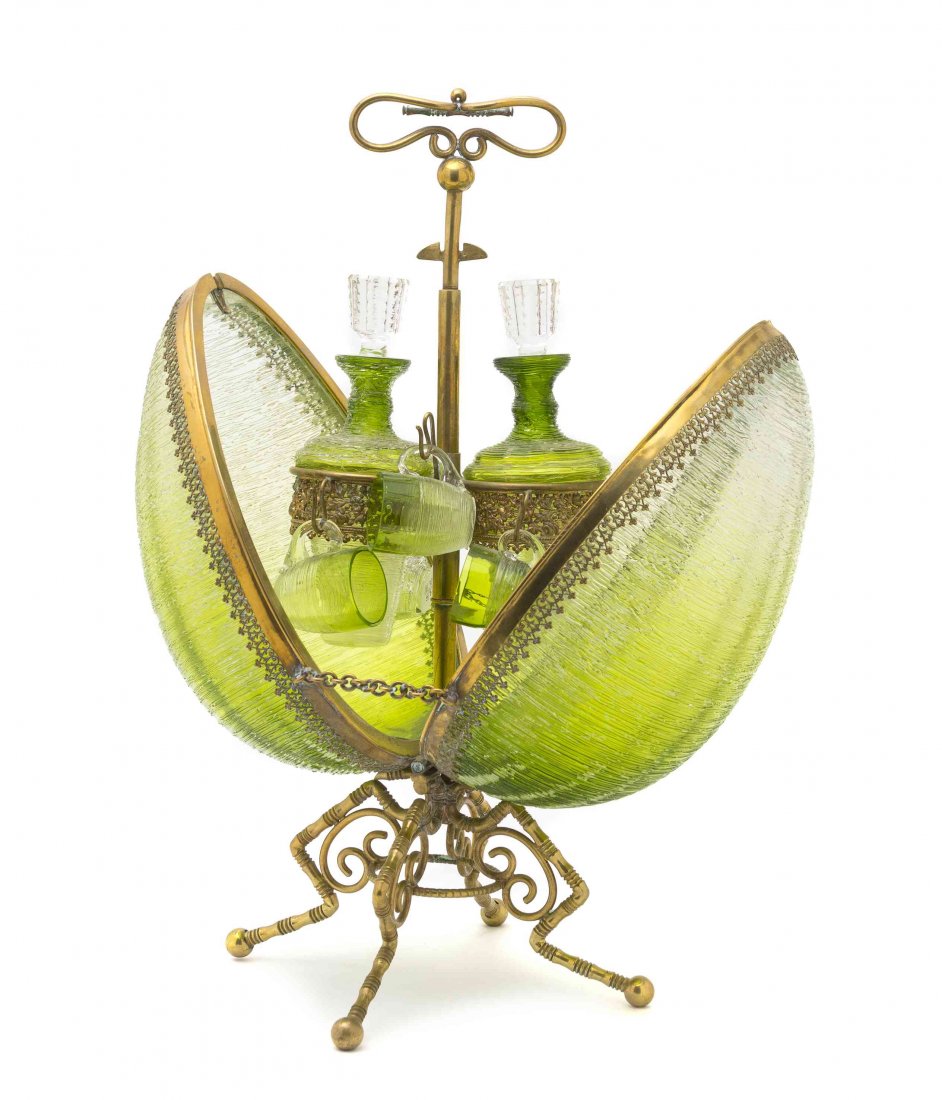 A Continental Gilt Bronze and Leaded Glass Decanter: A Continental Gilt Bronze and Leaded Glass Decanter Set, of ovoid form, opening to two bottles and six cordials. Height overall 17 1/4 inches.
