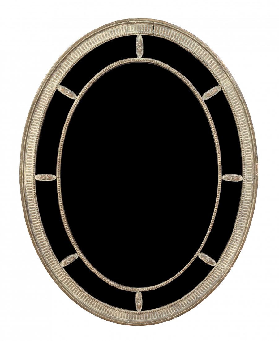 An Italian Wall Mirror, 19TH CENTURY, Height 57 inches.: An Italian Carved Wood Mirror, 19TH CENTURY, of oval form, within a fluted and rosette decorated frame. Height 57 x width 43 inches. Property from the Estate of Elizabeth Cheval, Lake Forest, Illinois