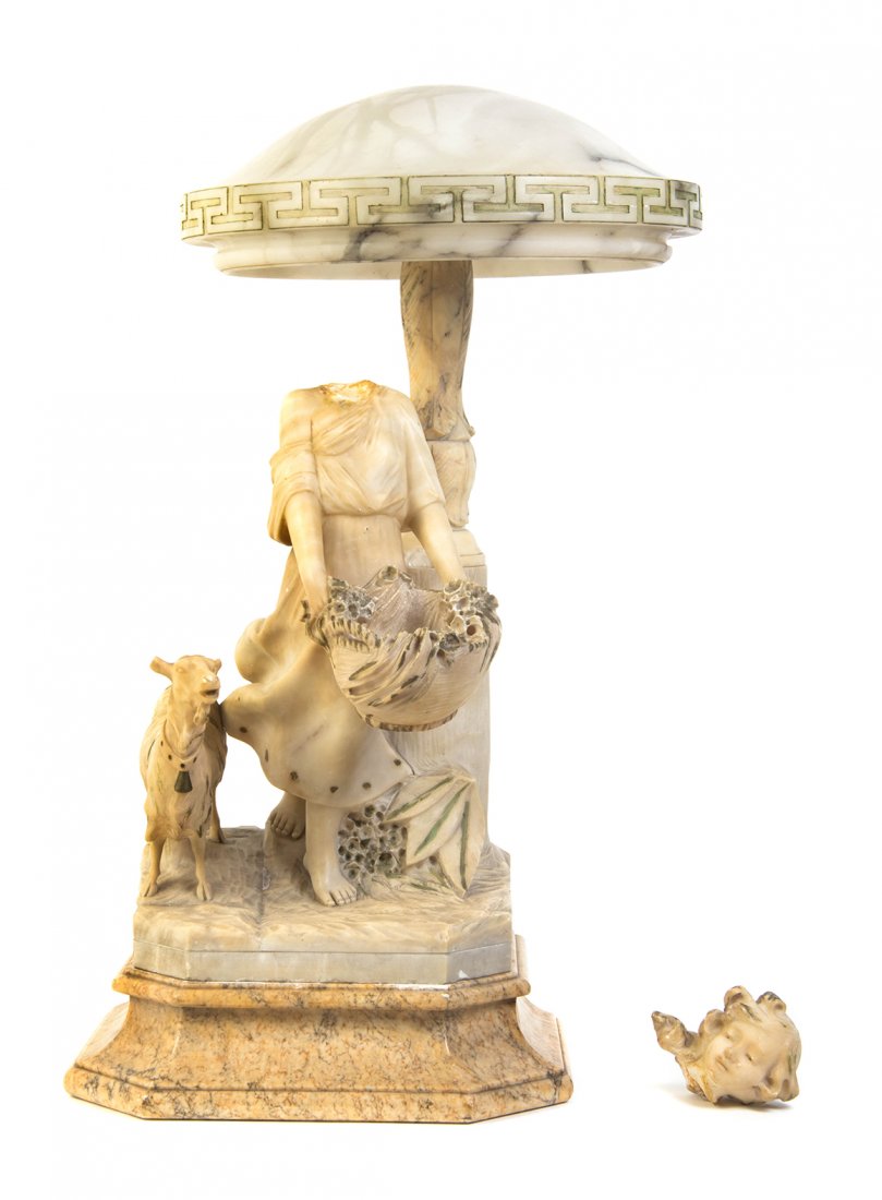 An Italian Alabaster Figural Lamp, TRINCIARELLI, Height: An Italian Alabaster Figural Lamp, TRINCIARELLI, depicting a shepherdess with a goat beneath a lighting element with Greek key decoration. Height 29 inches. Property from the Estate of Dr. Edward Spea