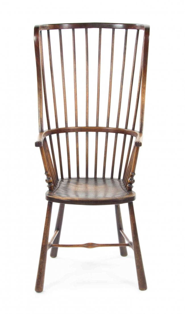 An English Oak Windsor Chair, Height 47 1/2 inches.: An English Oak Windsor Chair, having a spindle back and plank seat raised on tapering legs joined by an H-form stretcher. Height 47 1/2 inches.