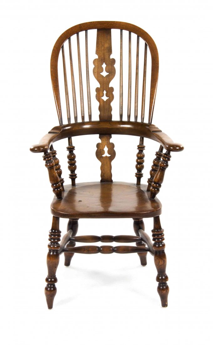 An English Walnut Windsor Chair, Height 45 1/2 inches.: An English Walnut Windsor Chair, with a pierced vertical splat and scrolled handholds, raised on turned legs joined by stretchers. Height 45 1/2 inches. Property from the Estate of Dorothy Parrott Hug