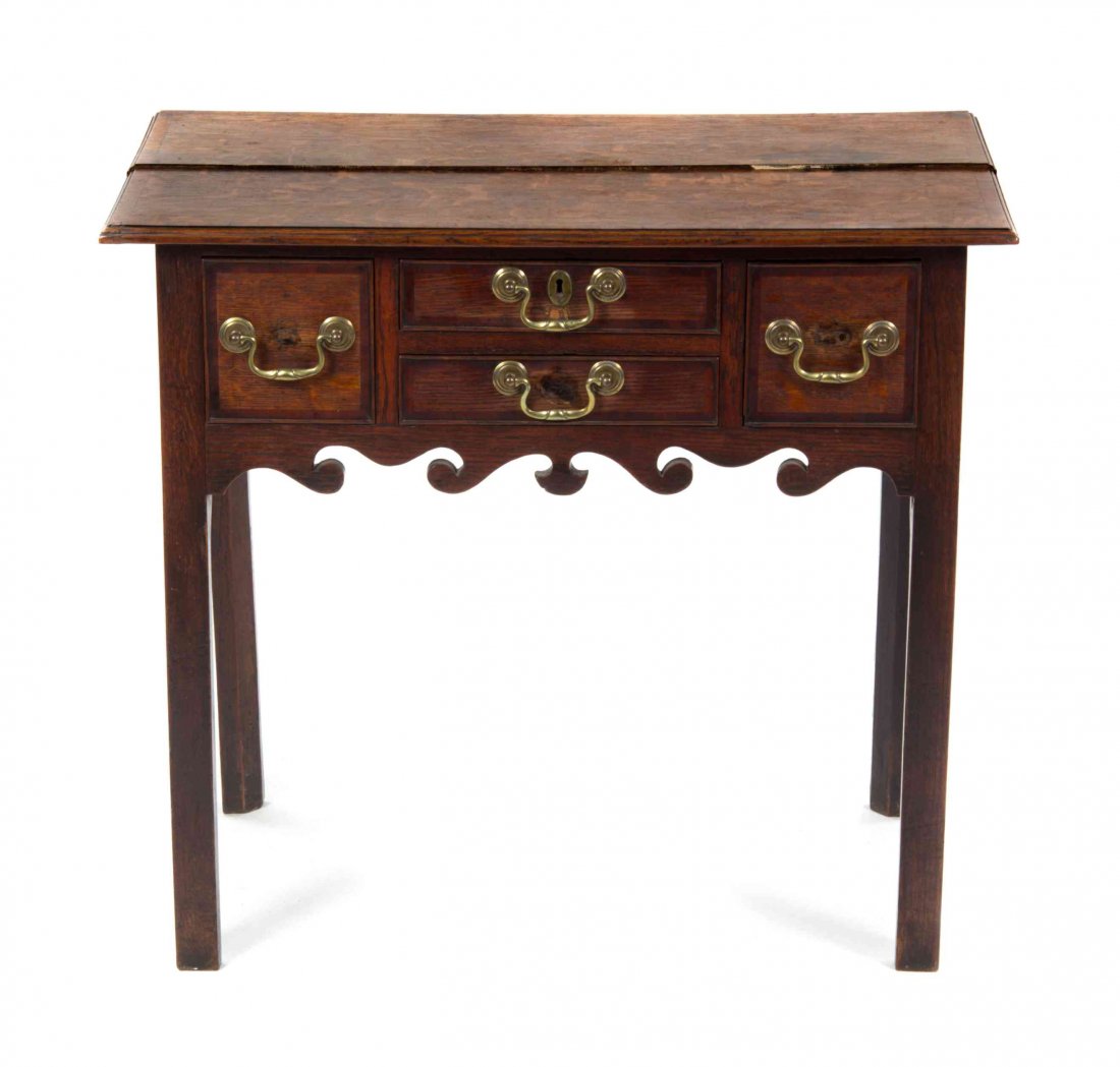 A George II Oak Lowboy, MID-18TH CENTURY, Height 28 1/2: A George II Oak Lowboy, MID-18TH CENTURY, having a rectangular top over two short drawers centering two deep drawers above a shaped frieze, raised on square legs. Height 28 1/2 x width 31 3/4 x depth