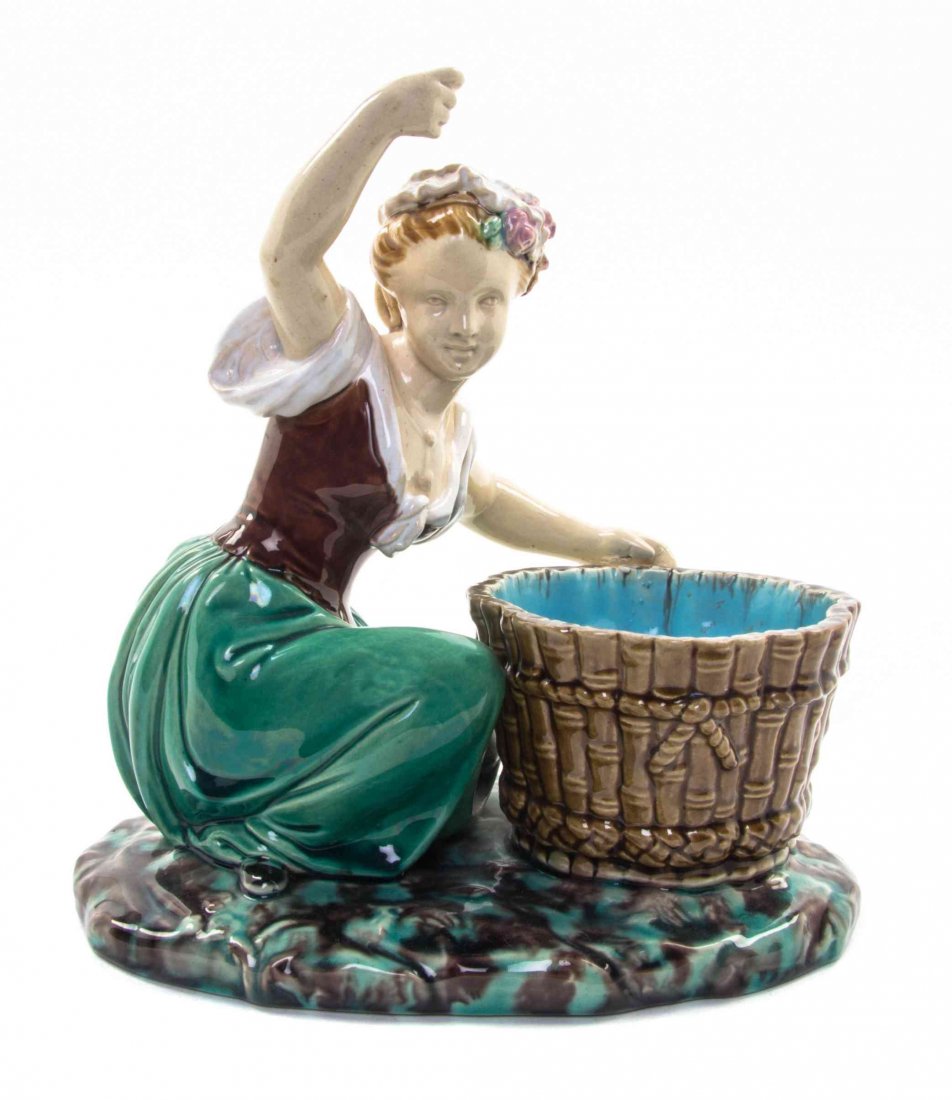 A Minton Majolica Master Salt, Height 8 inches.: A Minton Majolica Master Salt, modeled as a female vintner next to a basket. Height 8 inches. Property of a Lady, St. Augustine, Florida