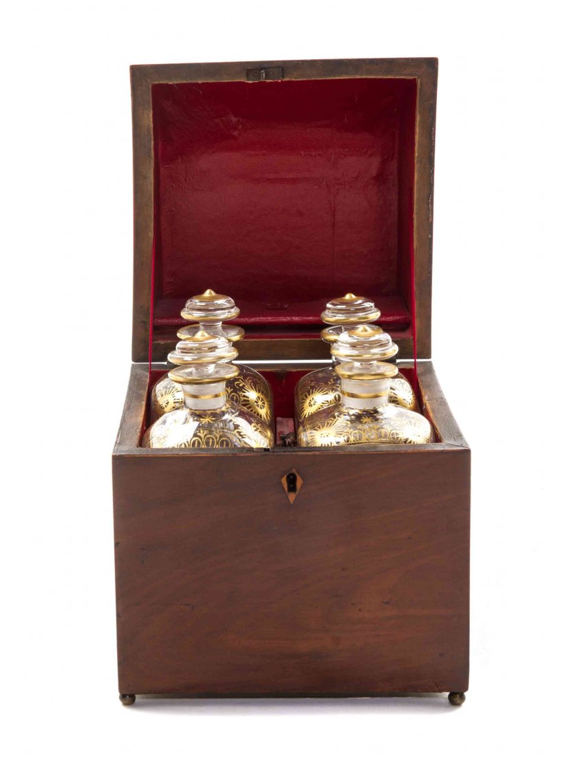 A Regency Mahogany Liquor Box, Height 9 1/8 x width 6: A Regency Mahogany Liquor Box, having a demi-domed hinged top opening to four gilt decorated glass decanters. Height 9 1/8 x width 6 7/8 x depth 6 7/8 inches. Property from the Collection of Judith D.