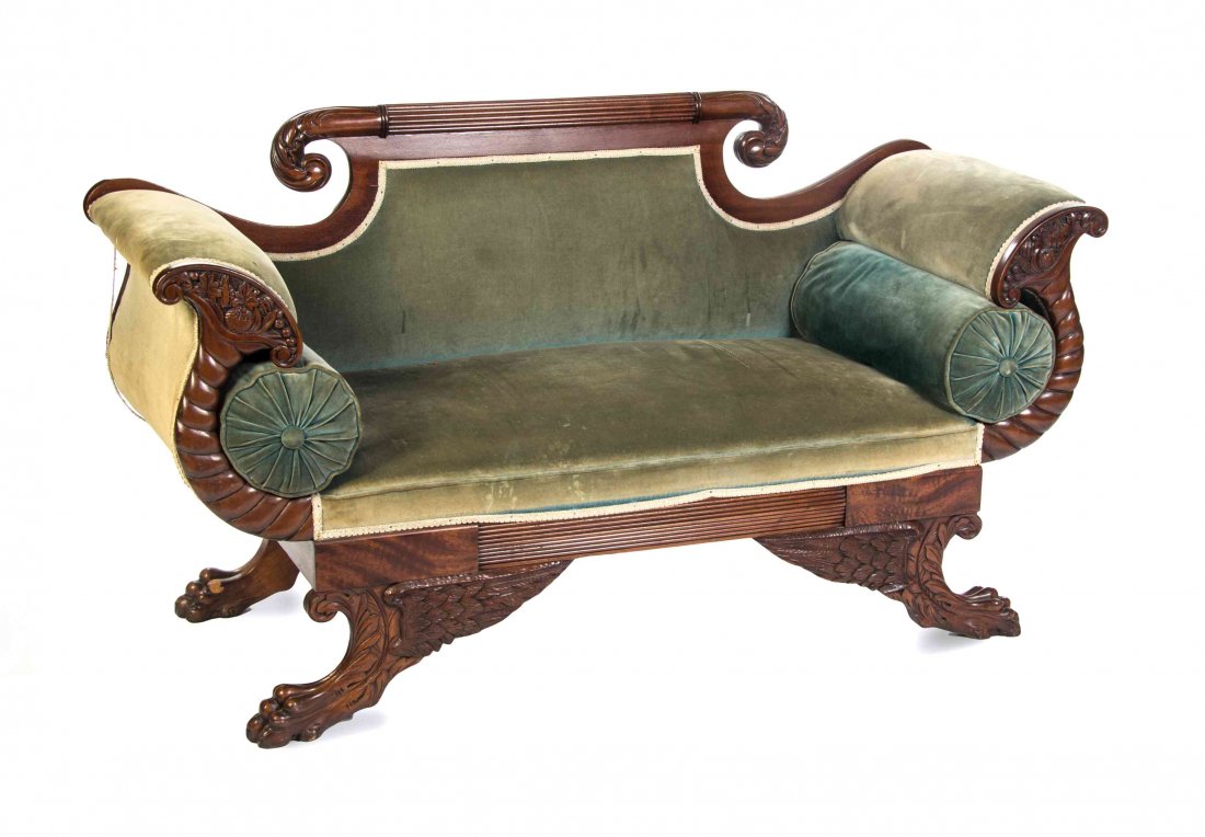 A Pair of American Classical Mahogany Settees, MID-19TH: A Pair of American Classical Mahogany Settees, MID-19TH CENTURY, each having a shaped padded back above a padded seat, flanked by cornucopia carved arms, raised on paw feet. Width 70 inches. Property