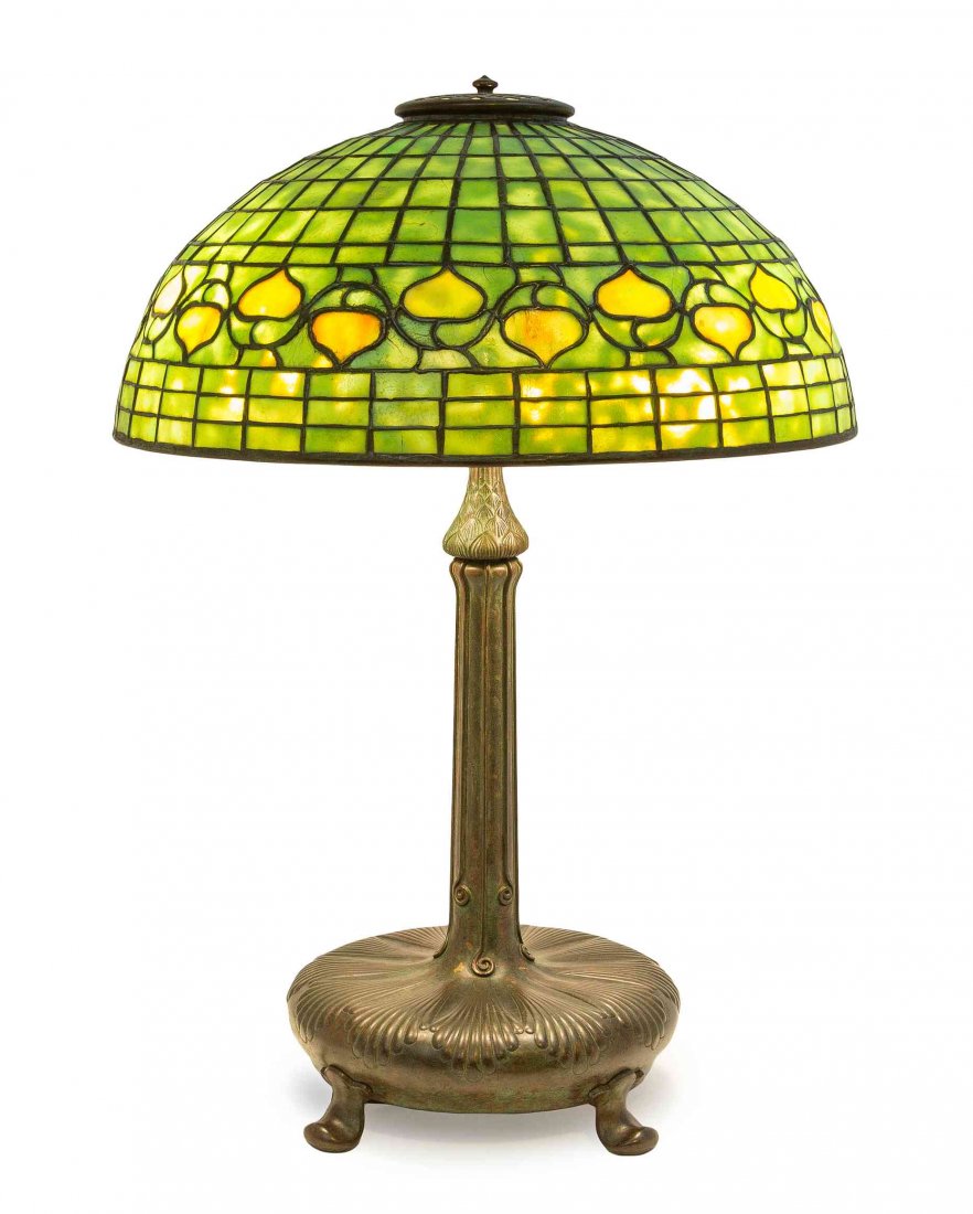 A Tiffany Studios Favrile Glass and Bronze Acorn Lamp,: A Tiffany Studios Favrile Glass and Bronze Acorn Lamp, the domed geometric shade with band of acorns, the base of baluster form with applied wirework decoration, raised on pad feet, the shade impresse