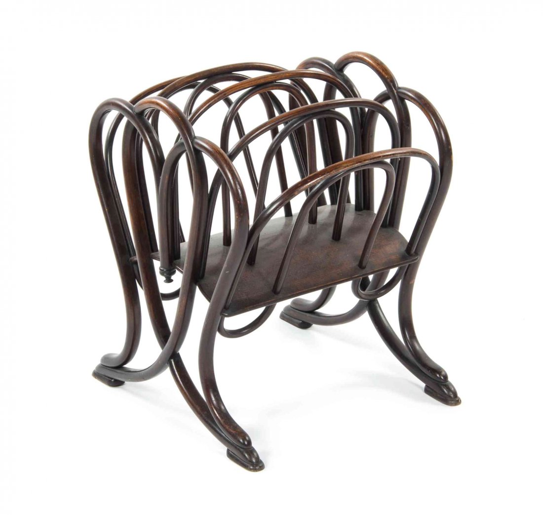 A Thonet Bentwood Canterbury, Height 21 1/8 x width 16: A Thonet Bentwood Canterbury, model number 11801, having four compartments within twin supports, raised on splayed legs terminating in stepped rectangular feet. Height 21 1/8 x width 16 x depth 21 inc