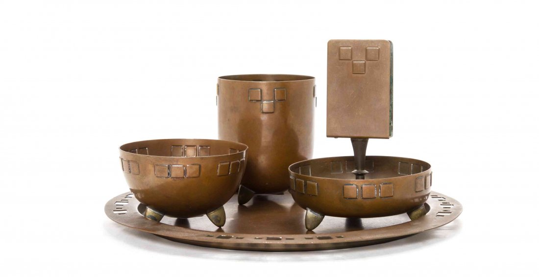 A Secessionist Style Copper Four-Piece Smoking Set,: A Secessionist Style Copper Four-Piece Smoking Set, comprising a matchbox safe with an undertray, a cigarette urn, an ash receiver and a circular tray. Diameter of tray 9 1/8 inches.