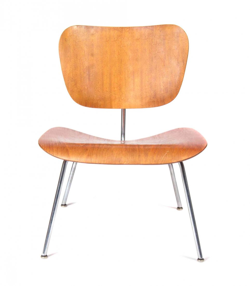 A Charles and Ray Eames Walnut DCM Chair, Height 27: A Charles and Ray Eames Walnut DCM Chair, with a molded back and seat, raised on tubular supports. Height 27 inches. Property from the Estate of Jean Friedlander, Milwaukee, Wisconsin
