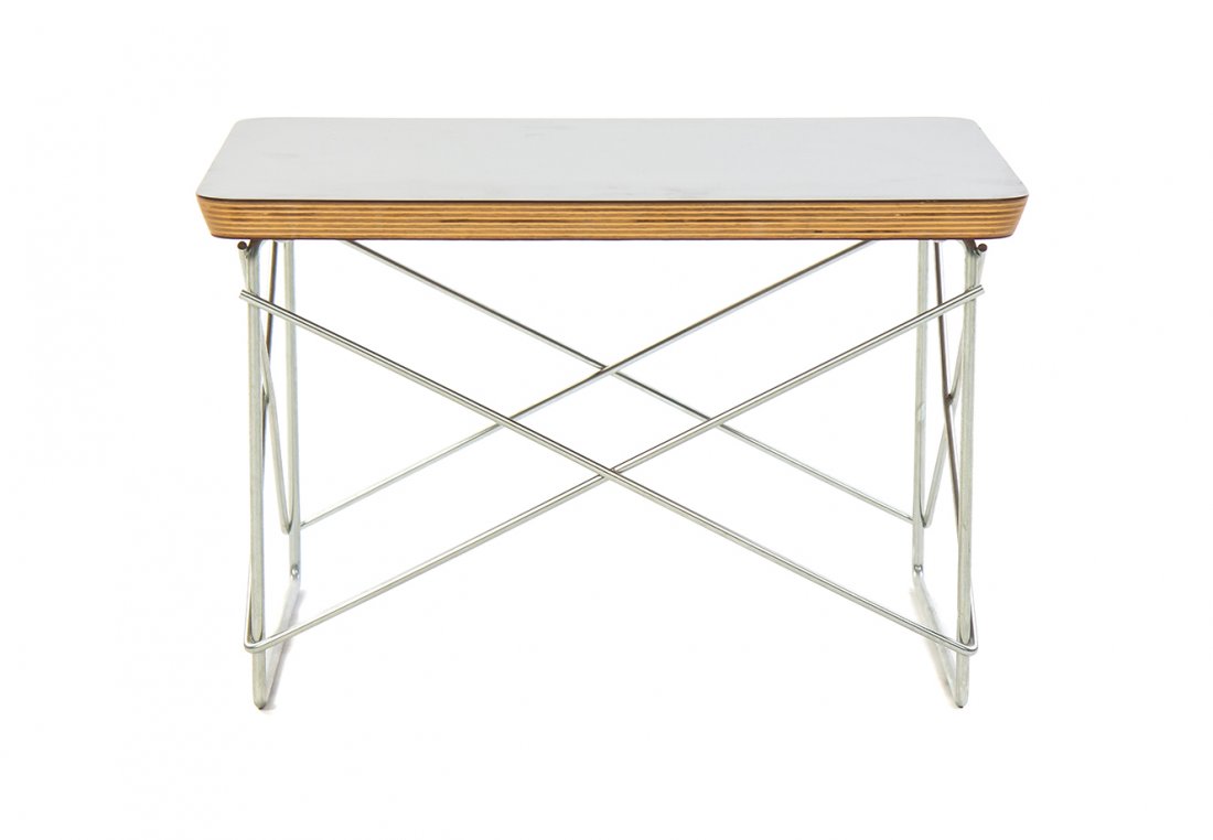 A Charles and Ray Eames Birch and Laminate LTR Table,: A Charles and Ray Eames Birch and Laminate LTR Table, having a rectangular top, raised on twin zinc supports, joined by stretchers, bearing the Herman Miller sticker. Height 9 3/4 x width 15 3/8 x dep
