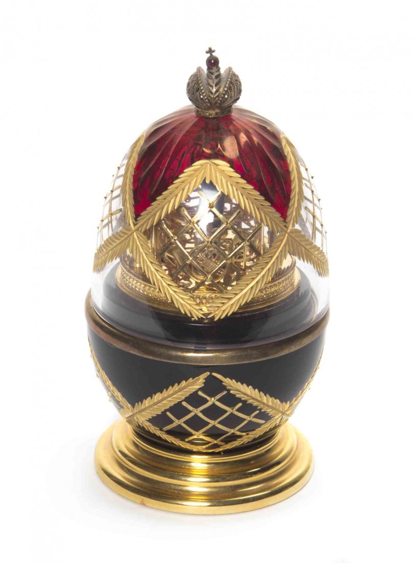 A Theo Faberge Egg Form Music Box, Height 5 7/8 inches.: A Theo Faberge Egg Form Music Box, titled Symphony, centered wth a conductor amidst musical instruments. Height 5 7/8 inches. Property from the Hugh Johnston Hubbard Trust, Lake Forest, Illinois