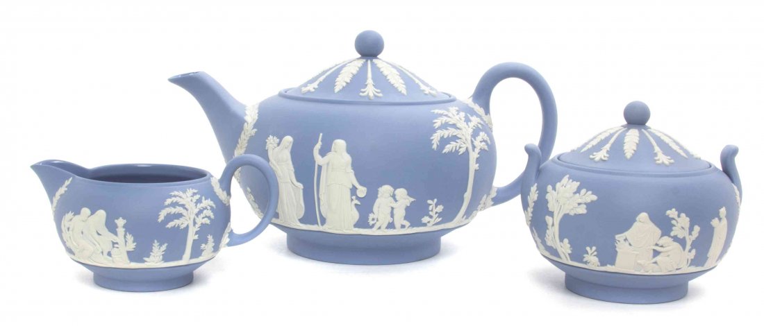 A Wedgwood Jasperware Three-Piece Tea Service, Width of: A Wedgwood Jasperware Three-Piece Tea Service, comprising a teapot, a covered sugar and a creamer. Width of first 8 1/2 inches.