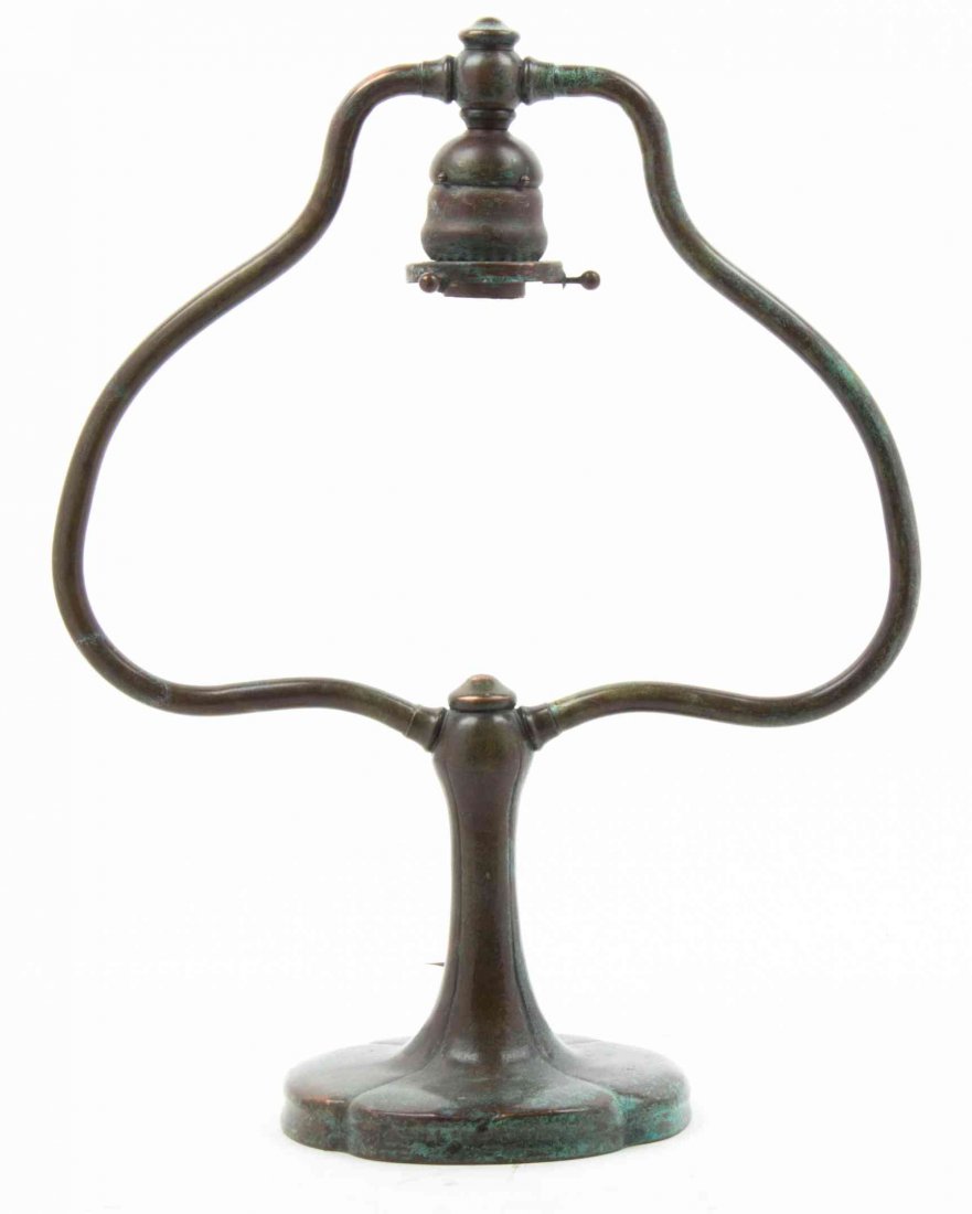 An American Patinated Bronze Desk Lamp Base, Height 17: An American Patinated Bronze Desk Lamp Base, of harp form with a tapering stem, bearing a spurious Tiffany Studios stamp. Height 17 inches.