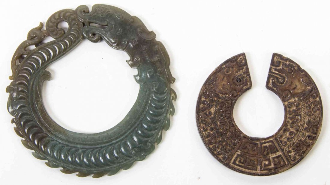 Two Archaistic Dragon Carvings, Diameter of larger 4: Two Archaistic Dragon Carvings, the first of a mottled green jade depicting a coiled dragon with relief carved scales and decoration, a smaller chilong carved to the top of its tail, the second of a r