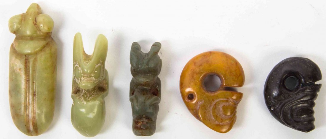 A Group of Five Carved Hardstone Toggles, Height of: A Group of Five Carved Hardstone Toggles, three of Liangzhu style carving depicting dragons, with a cicada and two other examples. Height of tallest 3 1/2 inches. Property from the Estate of Alan D. K